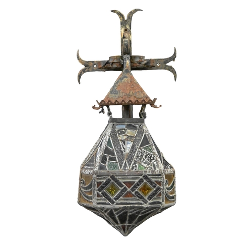 923 - An octagonal leaded glass hanging lantern, second quarter 20th c, of coloured glass in geometric pat... 