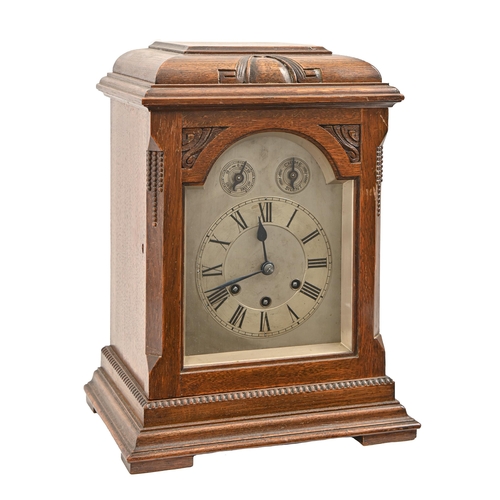 940 - A German oak mantel clock, early 20th c, with silvered dial and Gustav Becker three train movement c... 