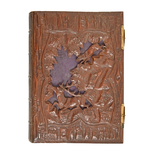 978 - A photograph album with Swiss carved walnut boards, c1900,  that to the cover with stag and hound in... 