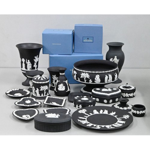 1415 - An extensive collection of Wedgwood black jasperware, including a footed bowl, vases, pin trays, som... 