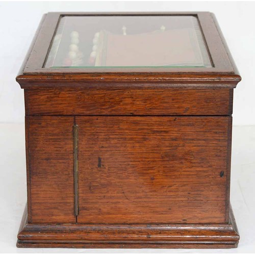 945 - A Victorian oak games compendium, Royal Cabinet of Games, the lid with bevelled glazed light and enc... 