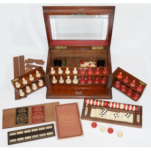 945 - A Victorian oak games compendium, Royal Cabinet of Games, the lid with bevelled glazed light and enc... 