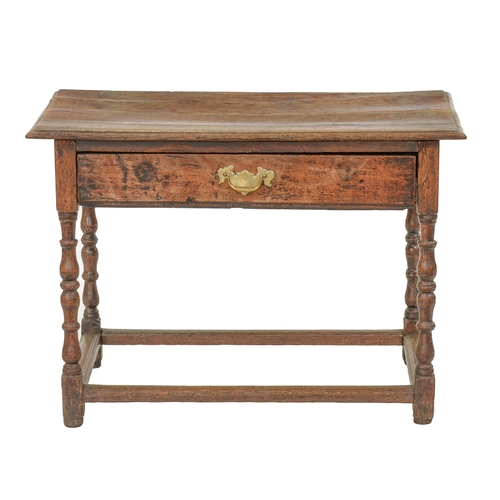 1203 - A William III joined oak side table, the oversailing top with moulded lip above full width drawer wi... 