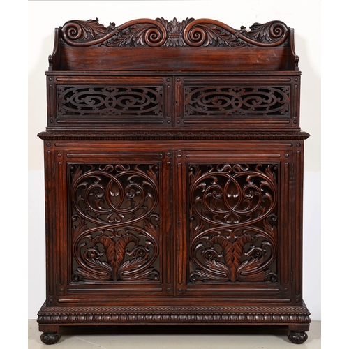 1355 - An Anglo-Indian carved and panelled padouk cabinet, 19th c, enclosed by fretwork and glazed doors, o... 