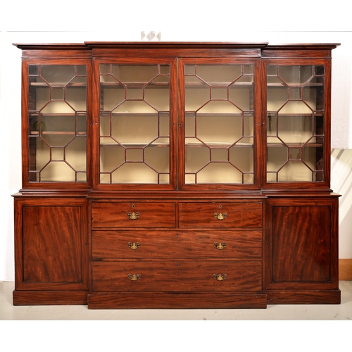 1357 - A George III mahogany breakfront bookcase, the upper part fitted with adjustable shelves enclosed by... 