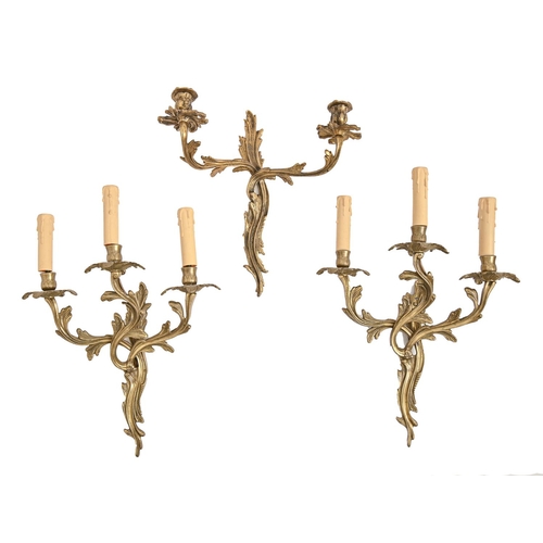 1002 - One and a pair of brass two or three branch wall lights, 20th c, in Louis XV style, 32 and 37cm h... 