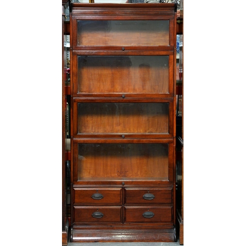 1195 - A mahogany sectional bookcase, early 20th c, in four graduated sections, each with glazed up-and-ove... 