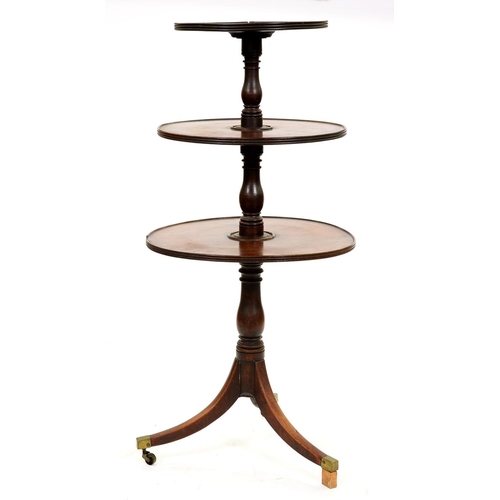 1317 - A George III mahogany dumb waiter, of three tiers with baluster shaft, on tripod with plain brass ca... 