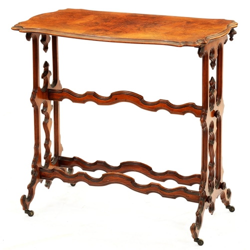 1323 - A Victorian serpentine walnut stretcher table, with quarter veneered top and three undulating stretc... 