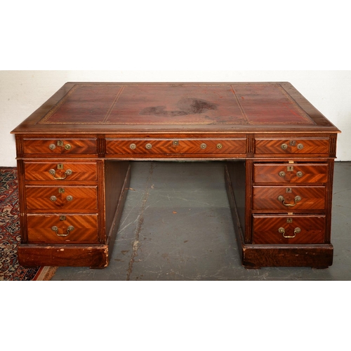 1349 - A mahogany partners desk, second quarter 20th c, both sides in matched chevron quarter veneers and f... 