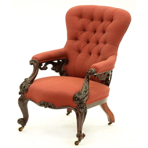 1350 - A Victorian mahogany armchair, with open arms and profusely carved with leafy scrolls, on volute fee... 