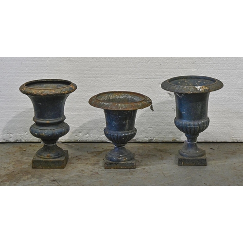 1383 - Three Victorian cast iron garden vases, c1900,  of campana shape, on square foot, 24-29cm h... 