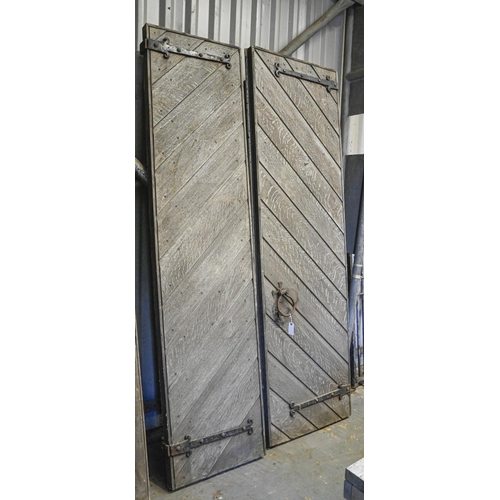 1391 - A pair of Victorian gothic oak diagonally boarded and ledged and braced doors,  with wrought iron fu... 