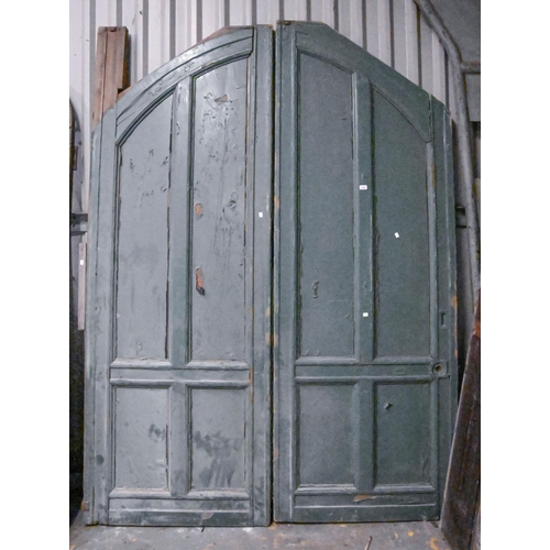 1393 - A substantial pair of Victorian green painted four panel wood arched doors,  259 h,  185cm l... 