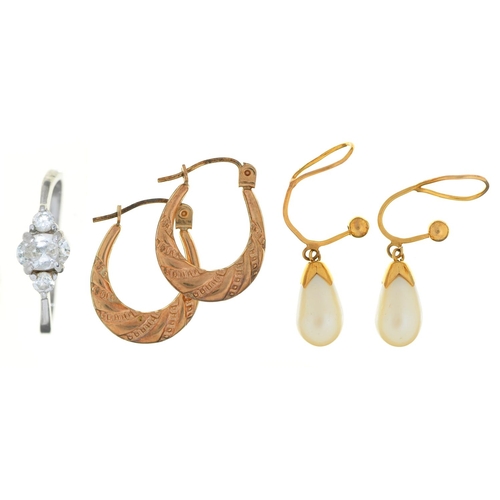 141 - A pair of gold hoop earrings, a pair of cultured pearl earrings and a white stone ring in white meta... 