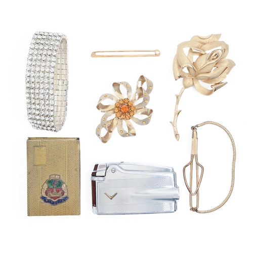 219 - Costume jewellery. A gold plated rose brooch and several other articles, including a Ronson lighter... 