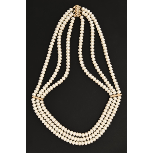 270 - A cultured pearl three strand necklace, with gold spacers, 42.5cm l, marked 14kt, 64.7g... 