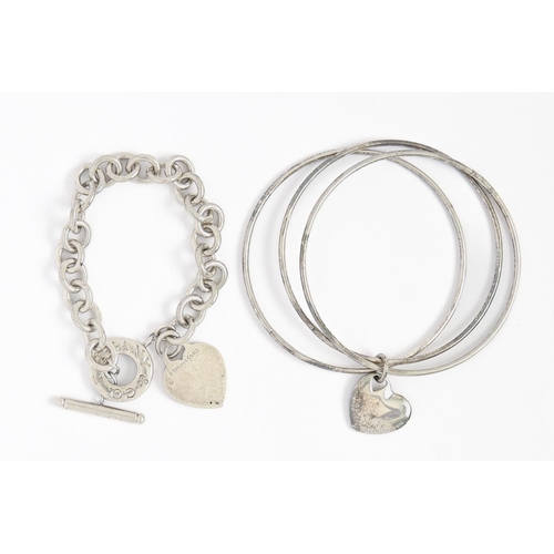 284 - Tiffany & Co. A silver bracelet and three bangles united by a heart, bracelet 21cm l, maker's ma... 