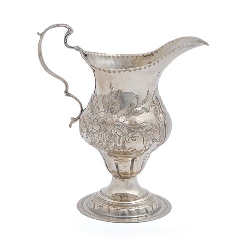 450 - A George III pear shaped silver cream jug, chased with baskets of fruit or flowers, 12.3cm h, by Tho... 