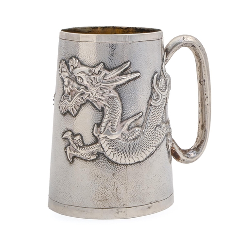 458 - A Chinese silver mug, c1900, of stippled, tapered cylindrical shape and applied with a repousse drag... 