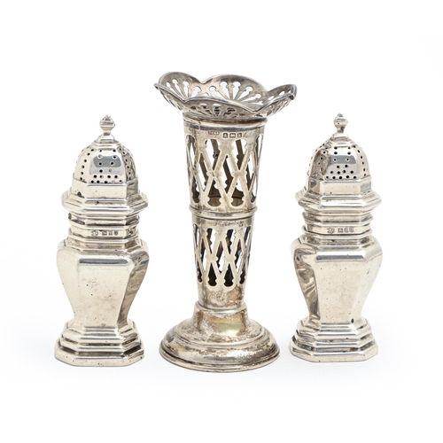 479 - A pair of George V silver pepperettes, 10cm h, by E Barnard & Sons Ltd, London 1911 and a pierce... 