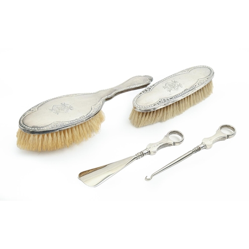 522 - An Edwardian silver hairbrush and matching clothes brush, marks rubbed, Chester 1908 and 1912, and a... 