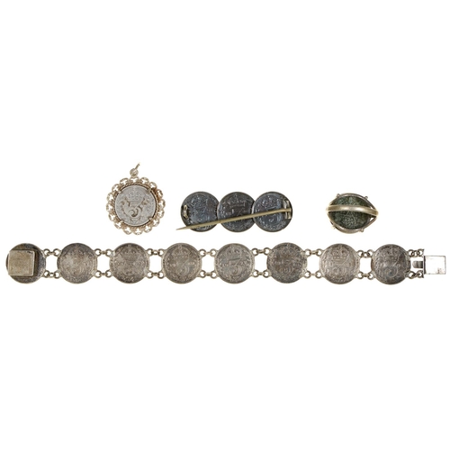 603 - A Victorian silver coin bracelet, a similar brooch, ring and pendant, 17dwts