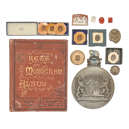 619 - A Victorian crests album, several wax seal impressions, boxed, two shell and lava cameos and miscell... 