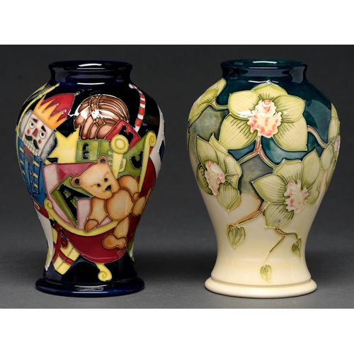 713 - Two Moorcroft vases, 2001 and 2012, in a Christmas or floral pattern, 15.5cm h, impressed and painte... 