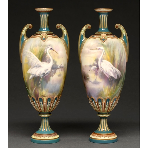 721 - A pair of Hadley's Worcester vases, 1902-1905, painted with egrets in a watery landscape with yellow... 