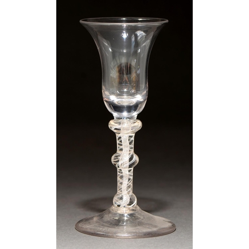 730 - A wine glass, c1760, the waisted bell bowl on triple knopped double series opaque twist stem and con... 