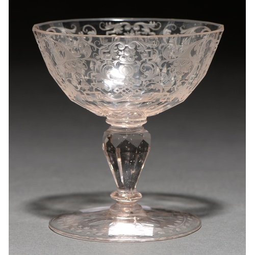 732 - A Saxon sweetmeat glass, c1740, the faceted oval bowl finely engraved with cornucopia, urns and stra... 