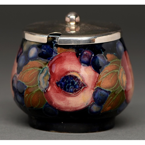 758 - A Moorcroft Pomegranate preserve pot, c1920, 68mm h, impressed marks and a metal cover (2)... 