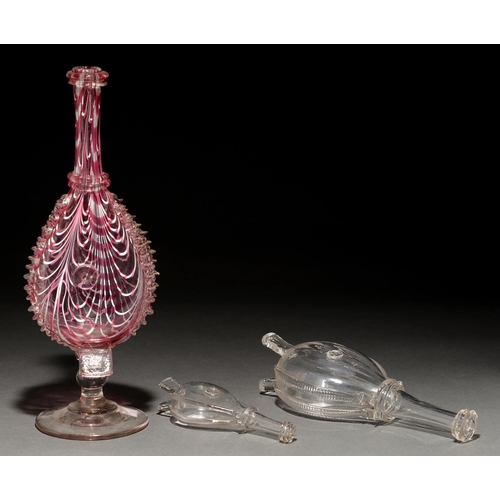 765 - A Victorian 'Nailsea' white and pink trailed glass bellows ornament and two bellows flasks,  the fir... 