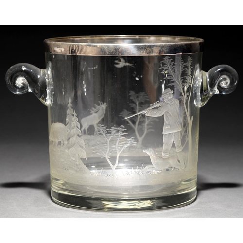 771 - A glass ice bucket with  scroll handles, wheel engraved with a continuous scene of a sportsman and d... 