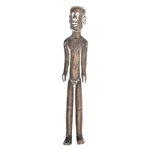 867 - Tribal art. A carved wood male doll, traces of white pigment, 30.5cm h