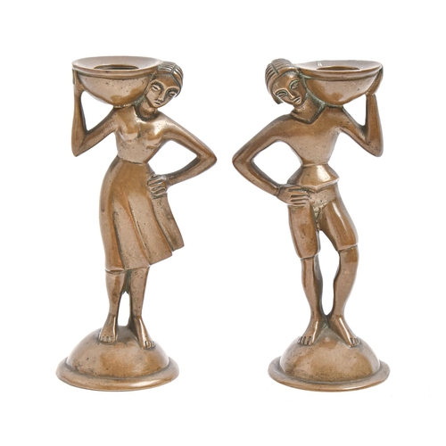 915 - A pair of Art Deco bronze  stylised figural figural candlesticks, c1930,  14cm h