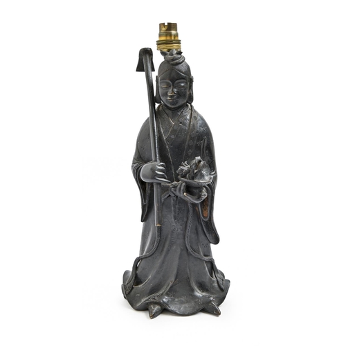 920 - A Chinese bronze sculpture of a female immortal, late 19th/early 20th c,  holding a flower in a bask... 