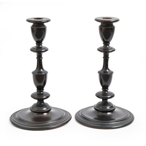 936 - A pair of turned and ebonised wood candlesticks, early 20th c, 25cm h