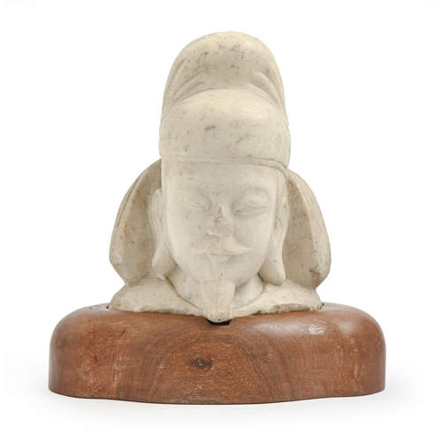 969 - A South East Asian marble sculpture of the head, of an immortal,  29cm h, on wood stand... 