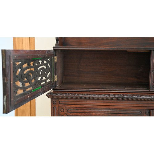 1355 - An Anglo-Indian carved and panelled padouk cabinet, 19th c, enclosed by fretwork and glazed doors, o... 