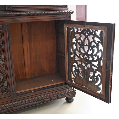 1355 - An Anglo-Indian carved and panelled padouk cabinet, 19th c, enclosed by fretwork and glazed doors, o... 