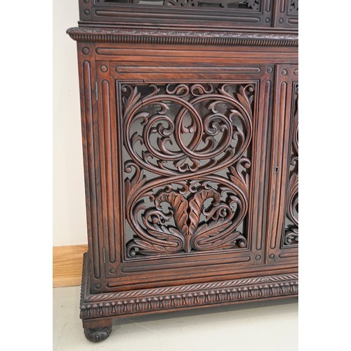 1355 - An Anglo-Indian carved and panelled padouk cabinet, 19th c, enclosed by fretwork and glazed doors, o... 