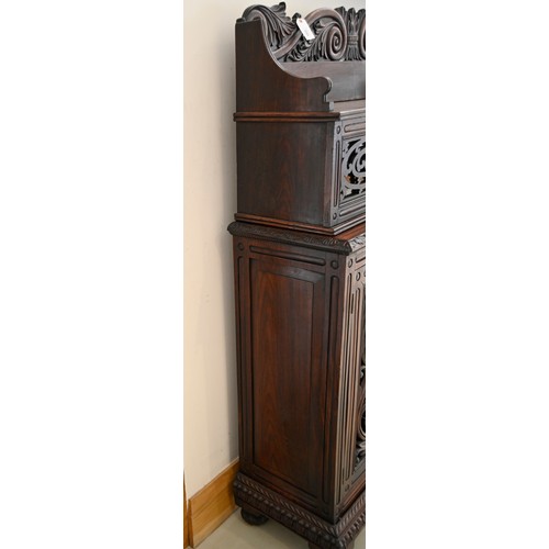 1355 - An Anglo-Indian carved and panelled padouk cabinet, 19th c, enclosed by fretwork and glazed doors, o... 