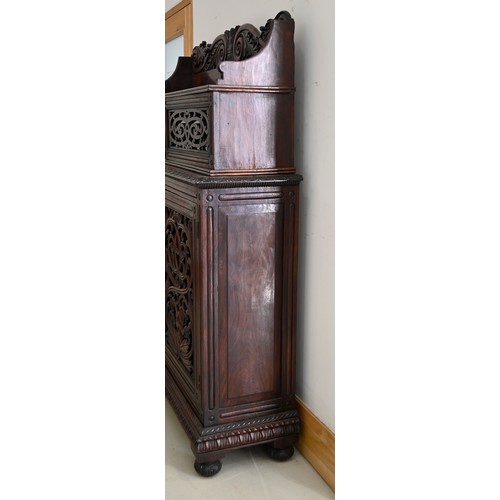 1355 - An Anglo-Indian carved and panelled padouk cabinet, 19th c, enclosed by fretwork and glazed doors, o... 