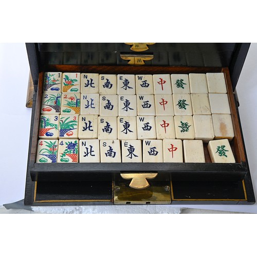 960 - A mahjong set in japanned cabinet, c1930, of bone and bamboo tiles and sticks, cabinet with hinged b... 