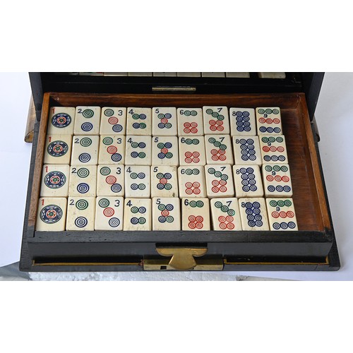 960 - A mahjong set in japanned cabinet, c1930, of bone and bamboo tiles and sticks, cabinet with hinged b... 