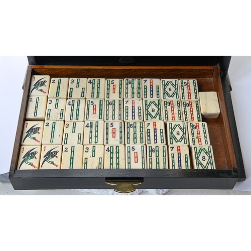 960 - A mahjong set in japanned cabinet, c1930, of bone and bamboo tiles and sticks, cabinet with hinged b... 