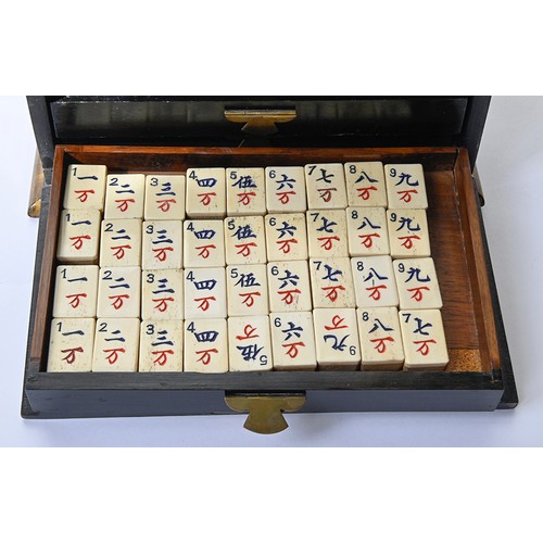 960 - A mahjong set in japanned cabinet, c1930, of bone and bamboo tiles and sticks, cabinet with hinged b... 