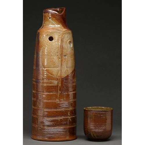 729 - Studio Pottery.  An English saltglazed brown stoneware vase, 1960,  incised with highly st... 